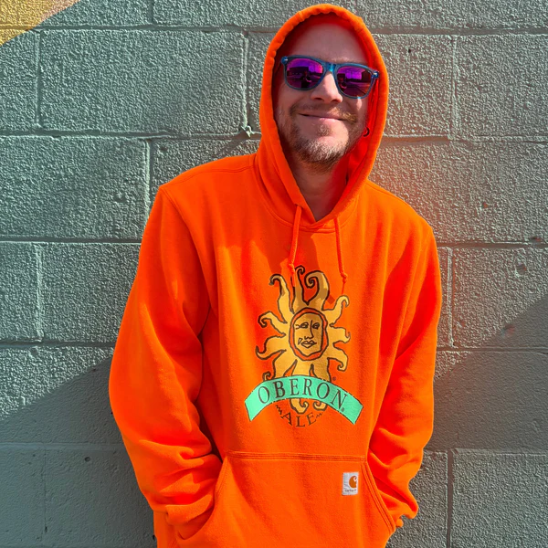 An orange Oberon branded pullover hooded sweatshirt